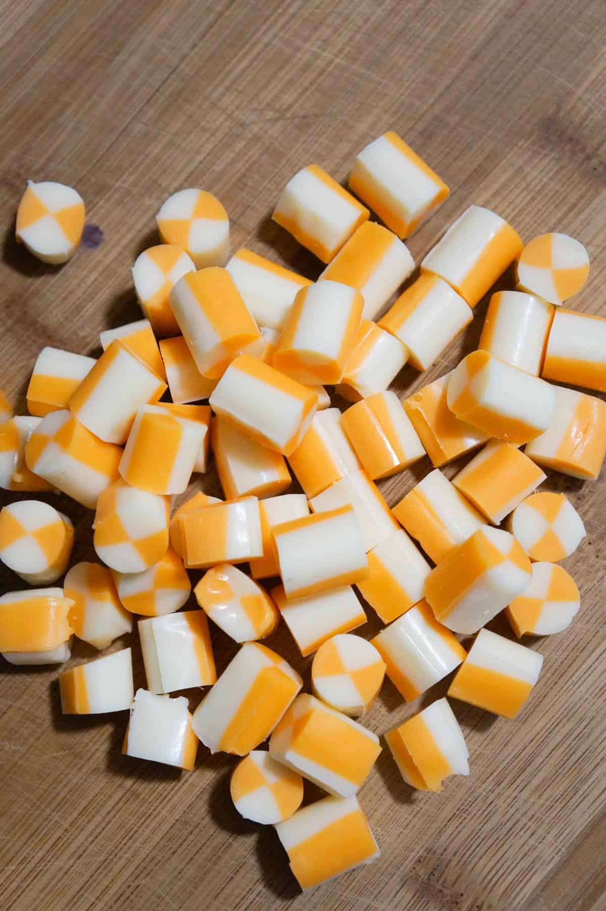 marble string cheese cut into cubes on a cutting board