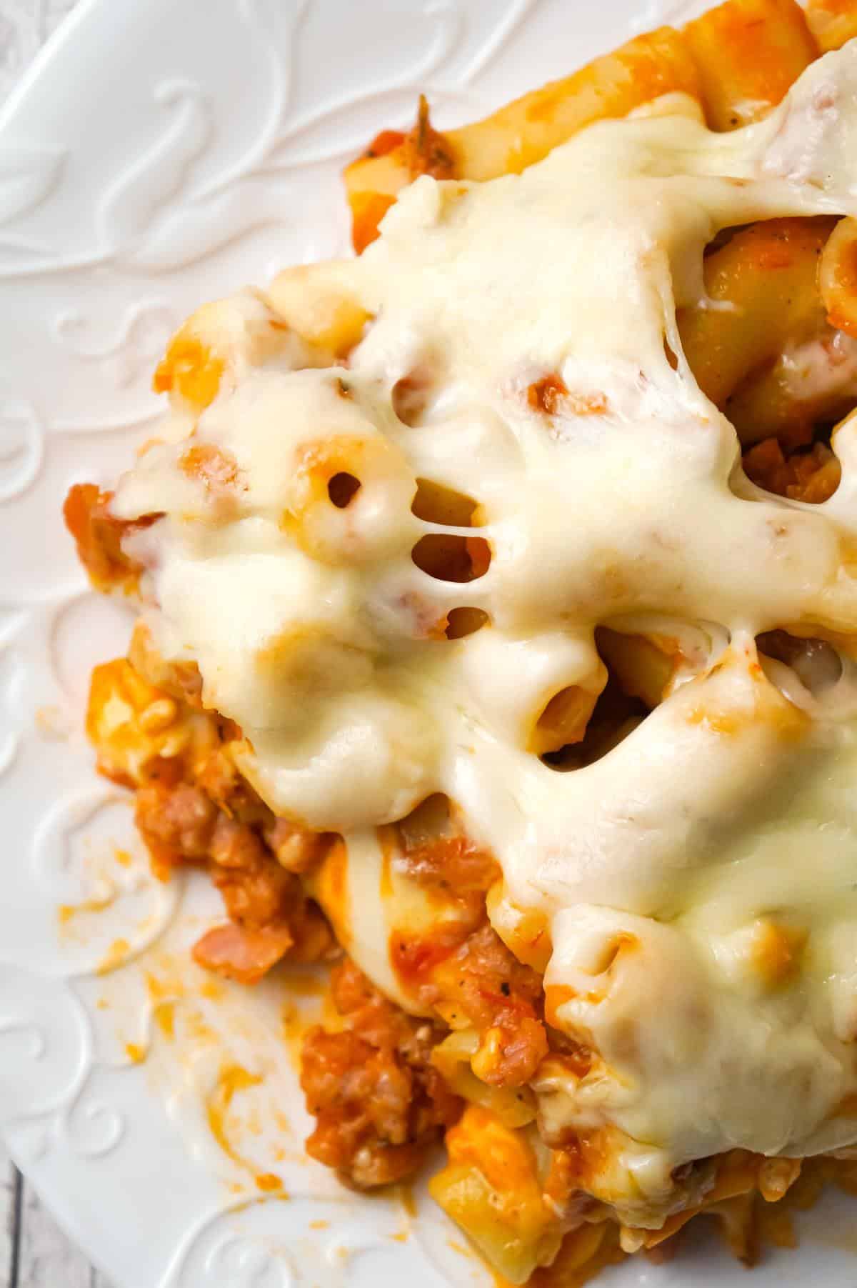 Baked Ziti with Sausage is an easy pasta recipe loaded with crumbled Italian sausage meat, marinara sauce, chunks of string cheese and shredded mozzarella.