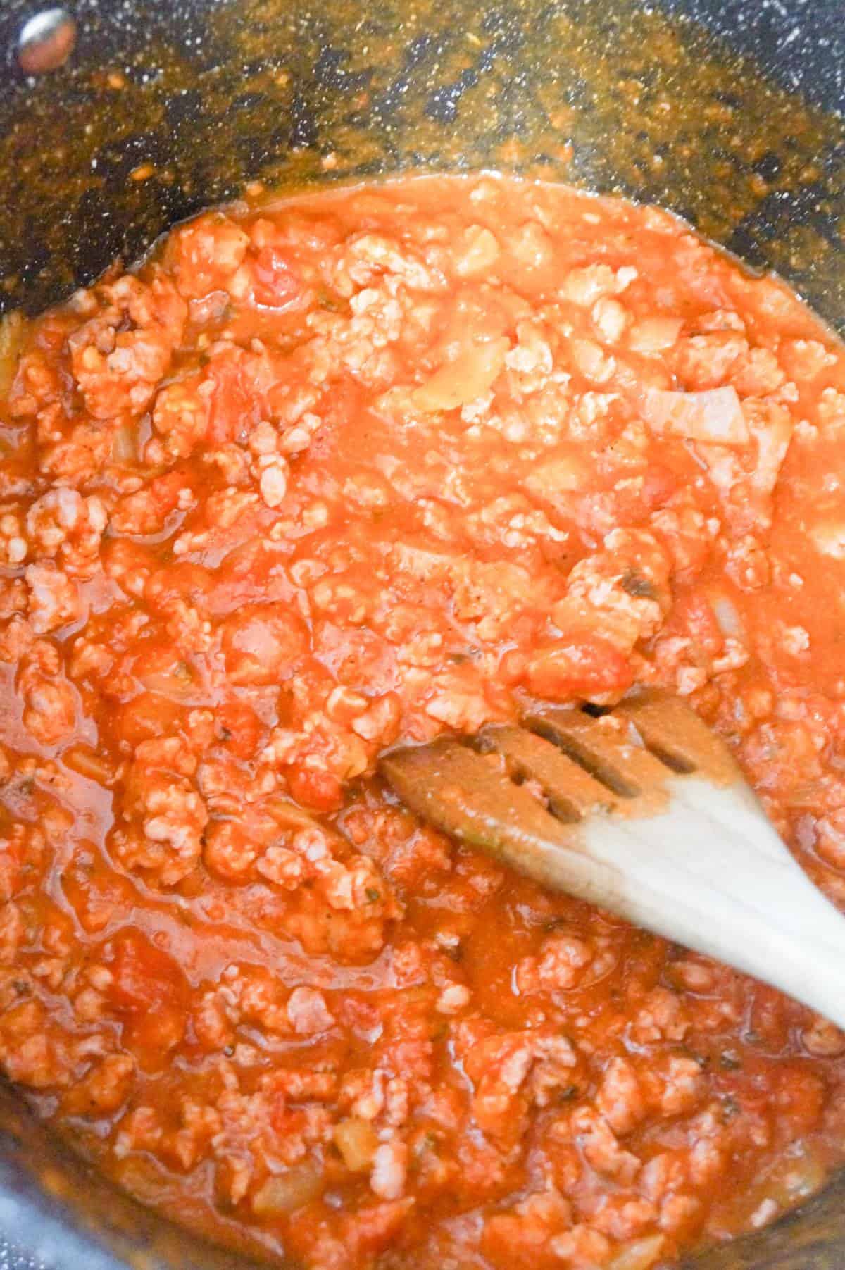 ground sausage meat and marinara sauce in a large pot