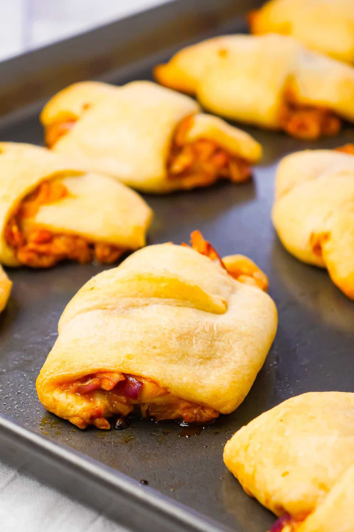 BBQ Chicken Crescent Rolls are an easy weeknight dinner recipe using shredded rotisserie chicken, diced red onions, Sweet Baby Ray's Barbecue sauce, shredded cheese and Pillsbury crescent rolls.