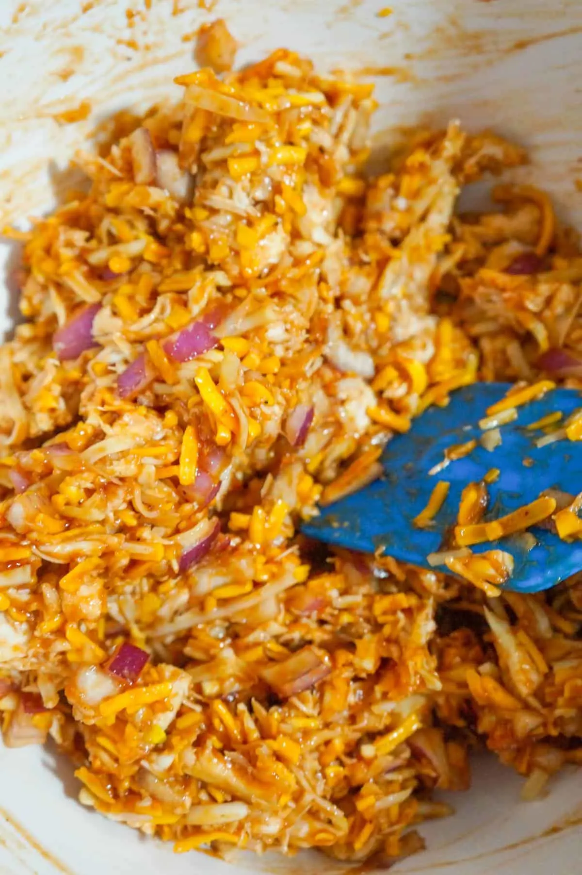 shredded bbq chicken mixture in a mixing bowl