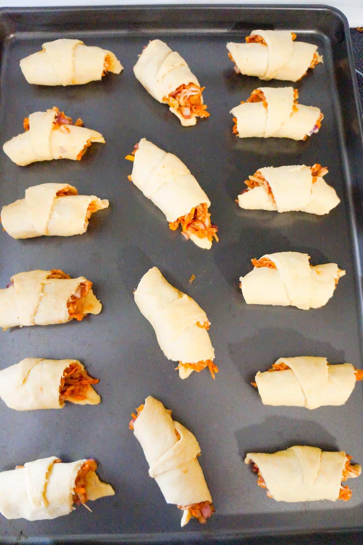 bbq chicken crescent rolls on a baking sheet before baking