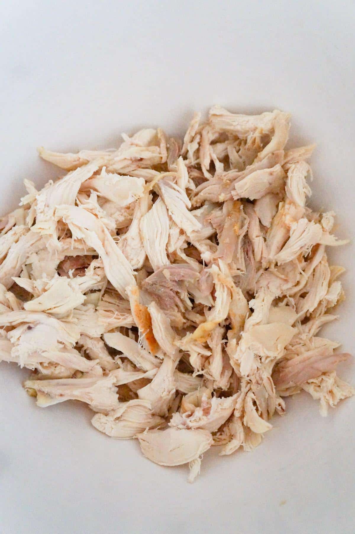 shredded chicken in a mixing bowl