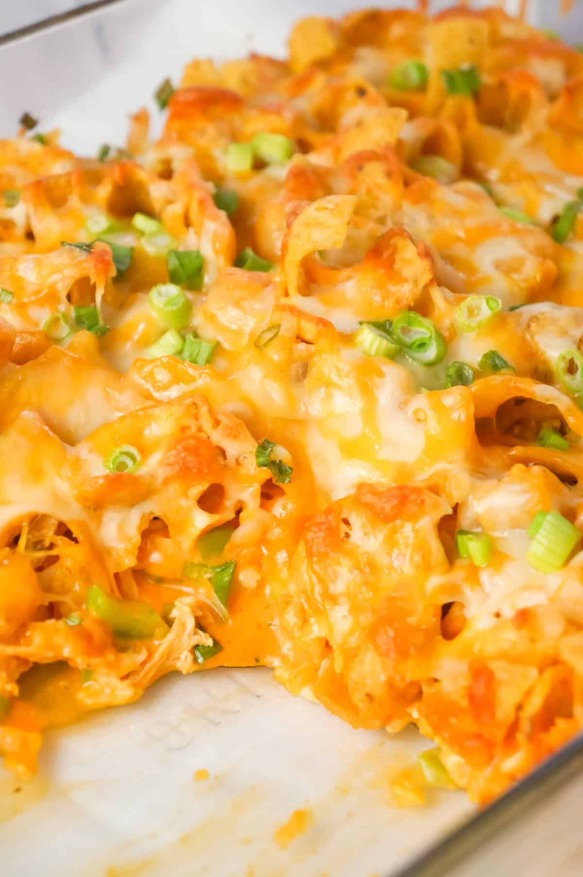 Buffalo Chicken Frito Pie is an easy casserole recipe using shredded rotisserie chicken and diced celery tossed in Buffalo sauce and ranch dressing, all topped with Fritos corn chips and cheese.