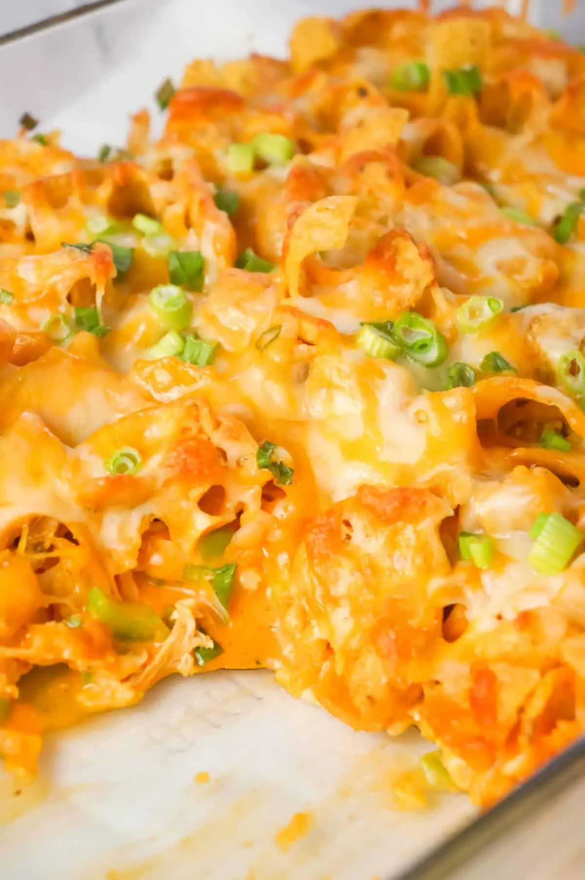 Buffalo Chicken Frito Pie is an easy casserole recipe using shredded rotisserie chicken and diced celery tossed in Buffalo sauce and ranch dressing, all topped with Fritos corn chips and cheese.
