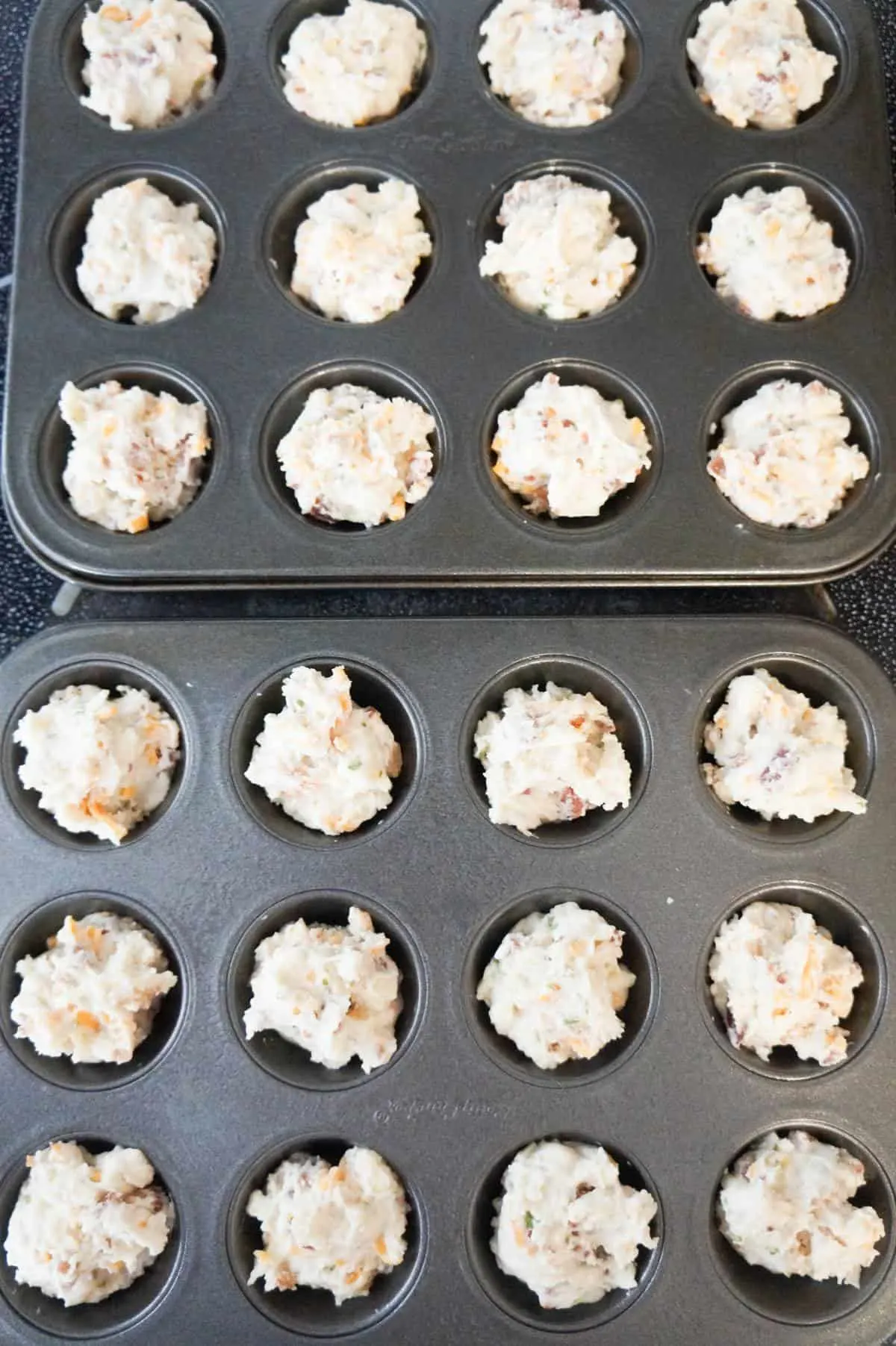 cheddar bacon biscuit dough in muffin tins