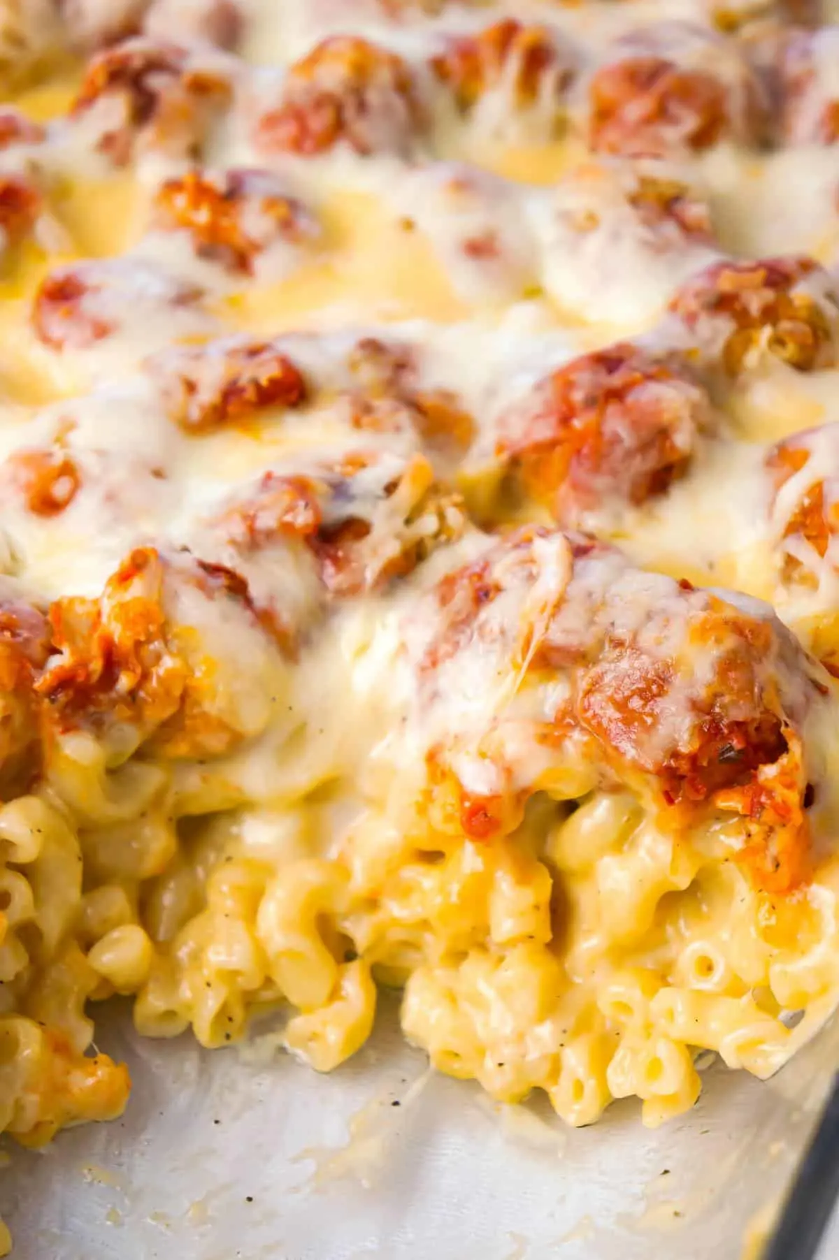 Chicken Parmesan Mac and Cheese is a hearty baked pasta recipe with a base of macaroni and cheese topped with popcorn chicken, marinara sauce and mozzarella cheese.