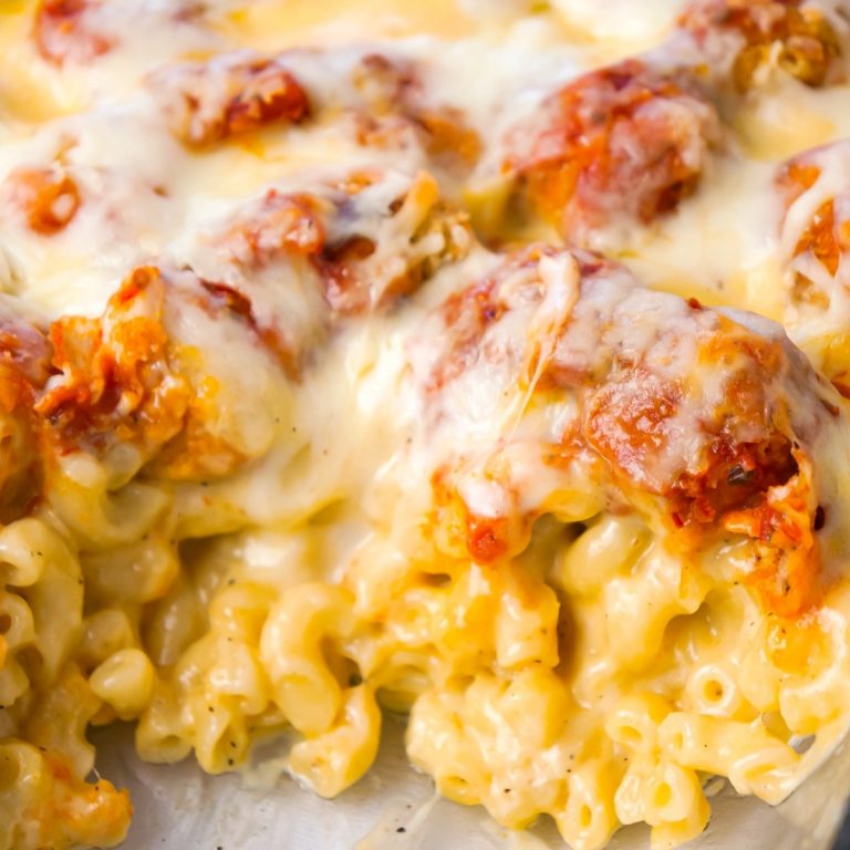Chicken Parmesan Mac and Cheese is a hearty baked pasta recipe with a base of macaroni and cheese topped with popcorn chicken, marinara sauce and mozzarella cheese.