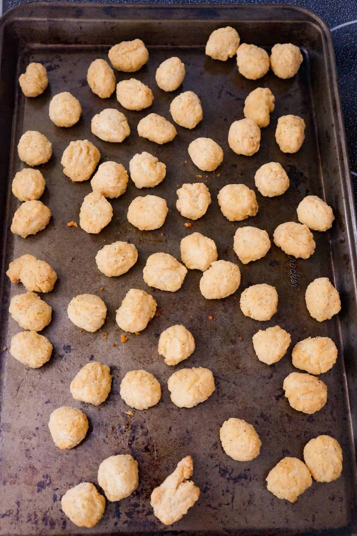 popcorn chicken on a baking sheet