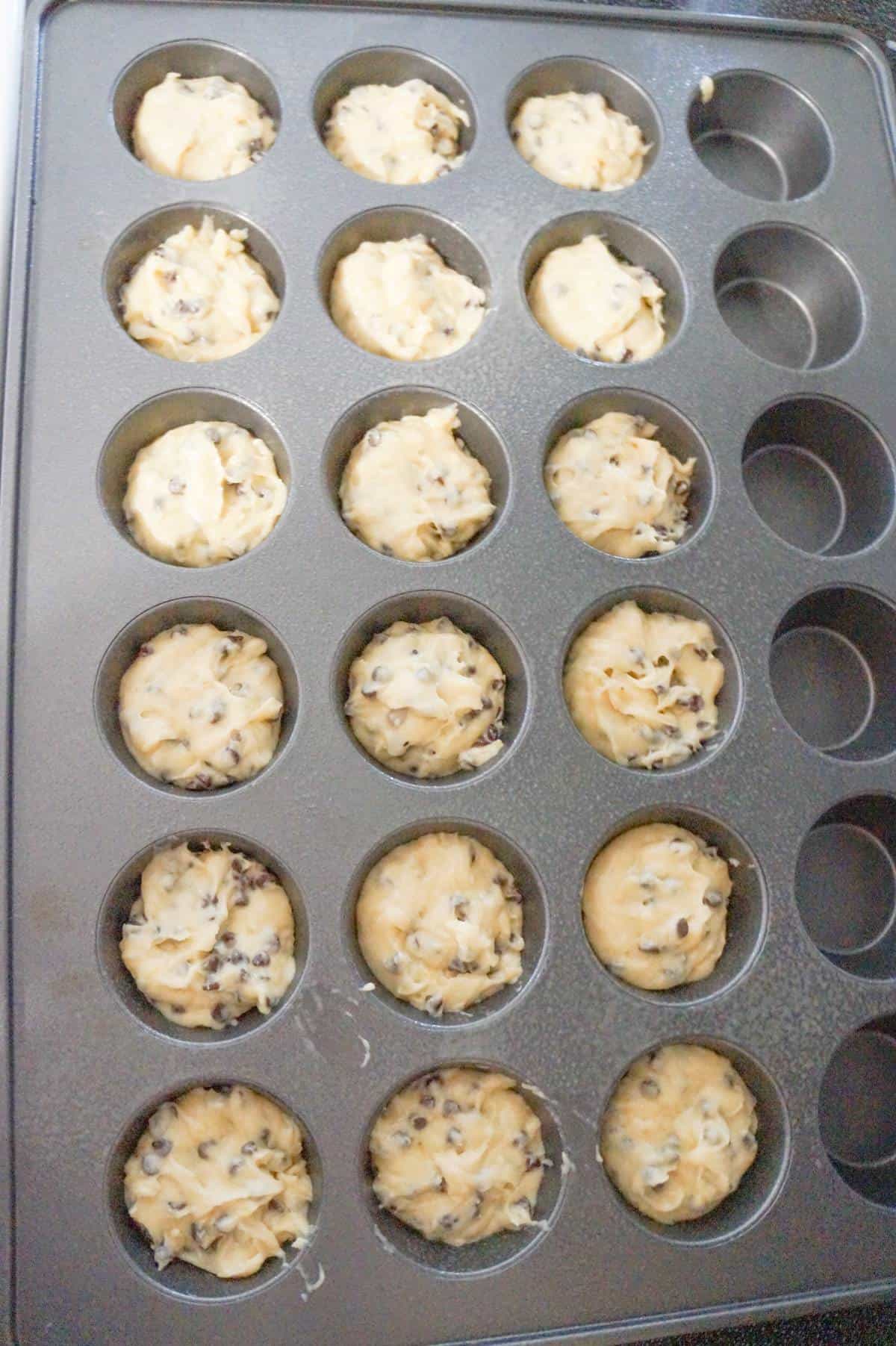 banana chocolate chip muffin batter in a muffin tin