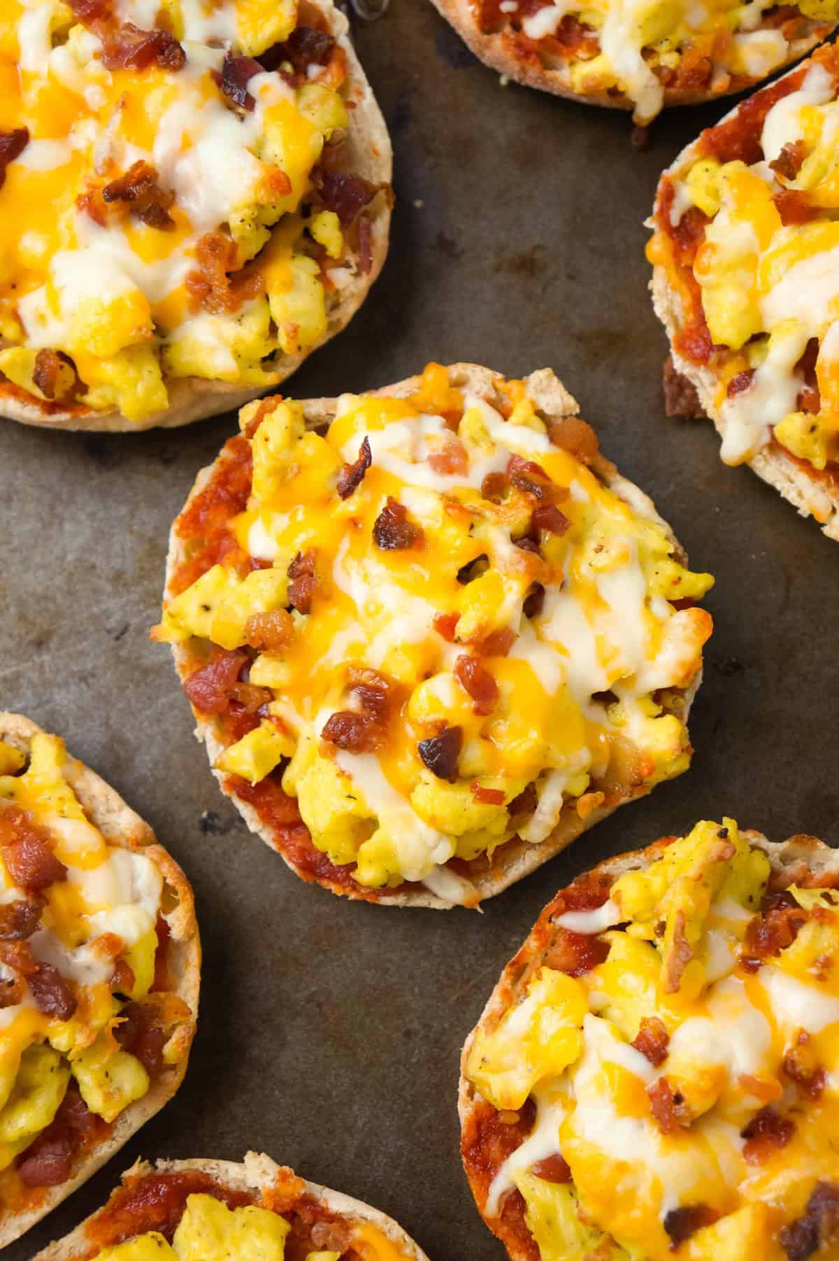 English Muffin Breakfast Pizzas are an easy breakfast or brunch recipe using English muffins and topped with Heinz chili sauce, scrambled eggs, crumbled bacon and shredded cheese.