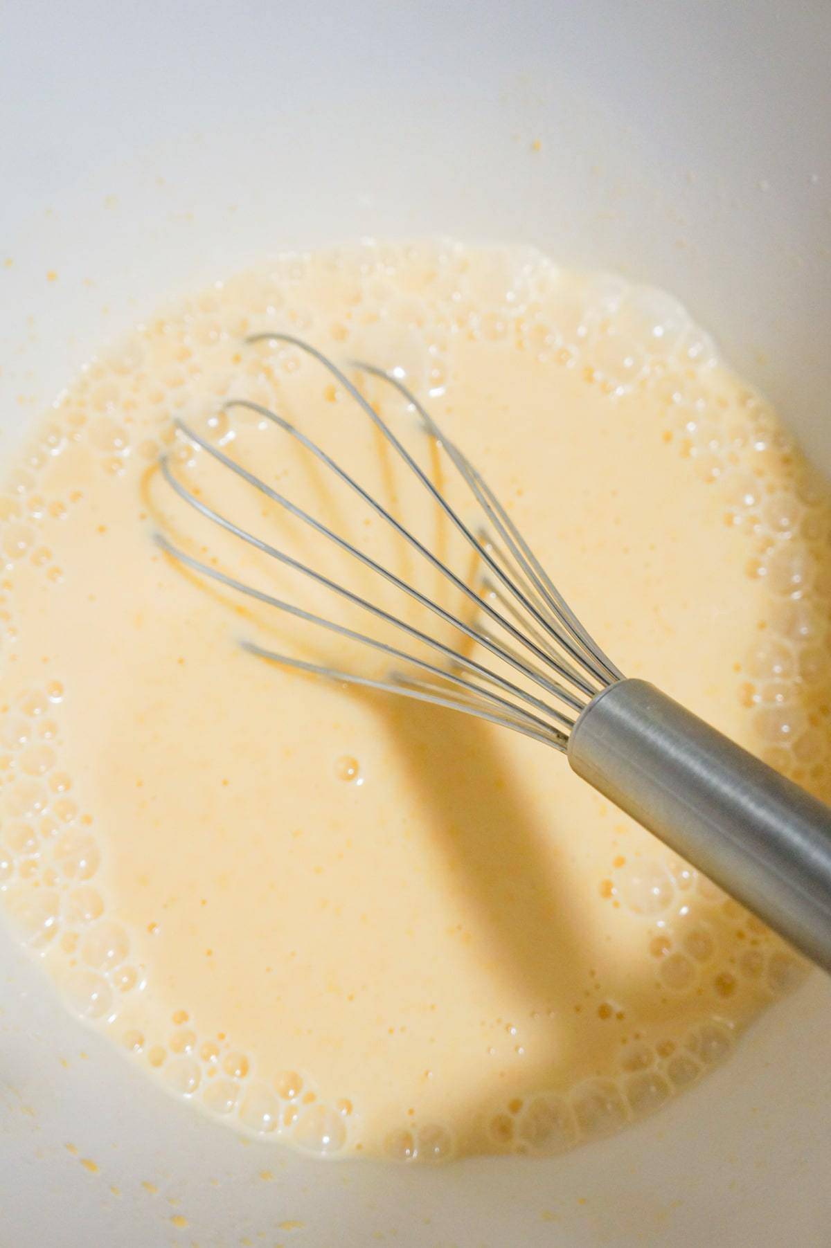 milk and cheddar cheese soup mixture in a mixing bowl