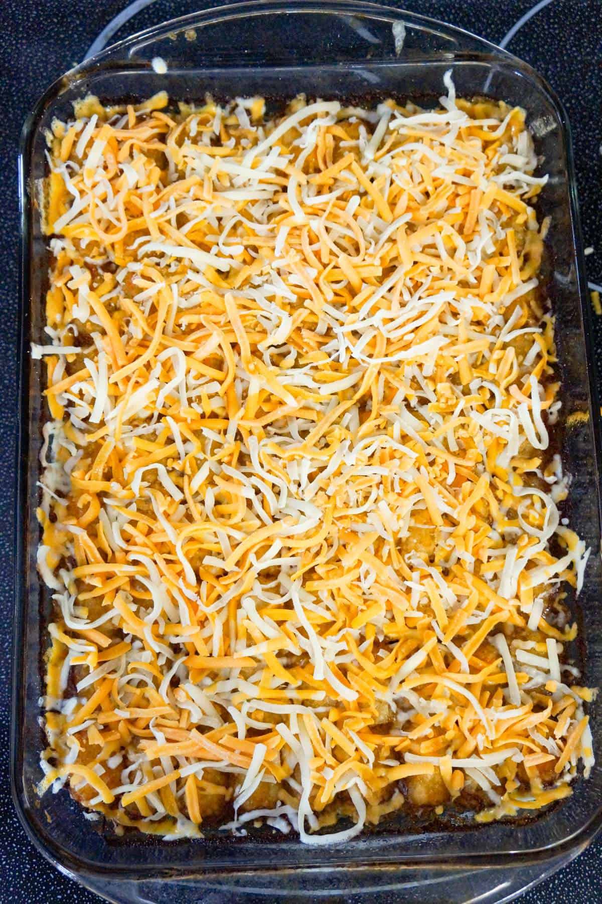 shredded mozzarella and cheddar cheese on top of tater tot casserole