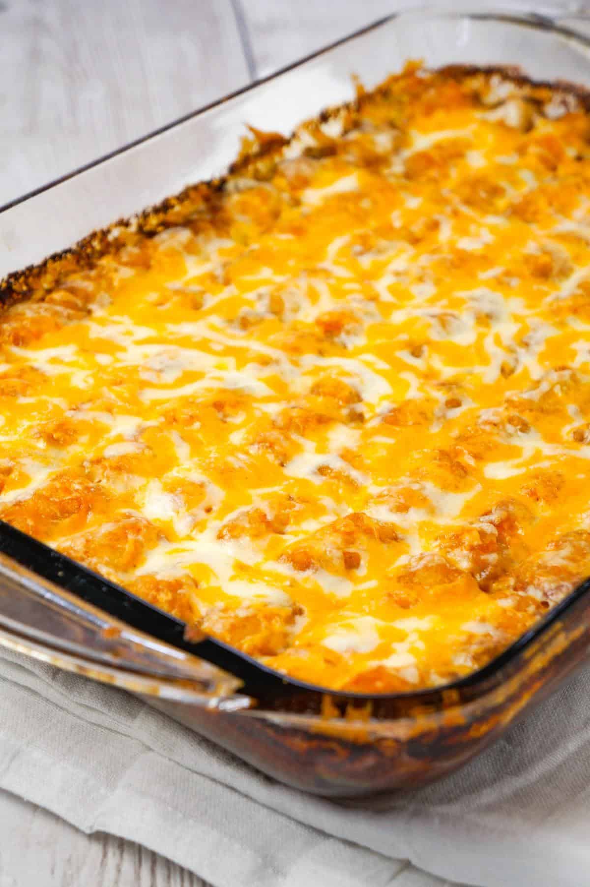 Philly Cheese Steak Tater Tot Casserole is a hearty dinner recipe with a base of ground beef, diced onion, diced green peppers and sliced mushrooms tossed in brown gravy and topped with shredded cheese and tater tots.