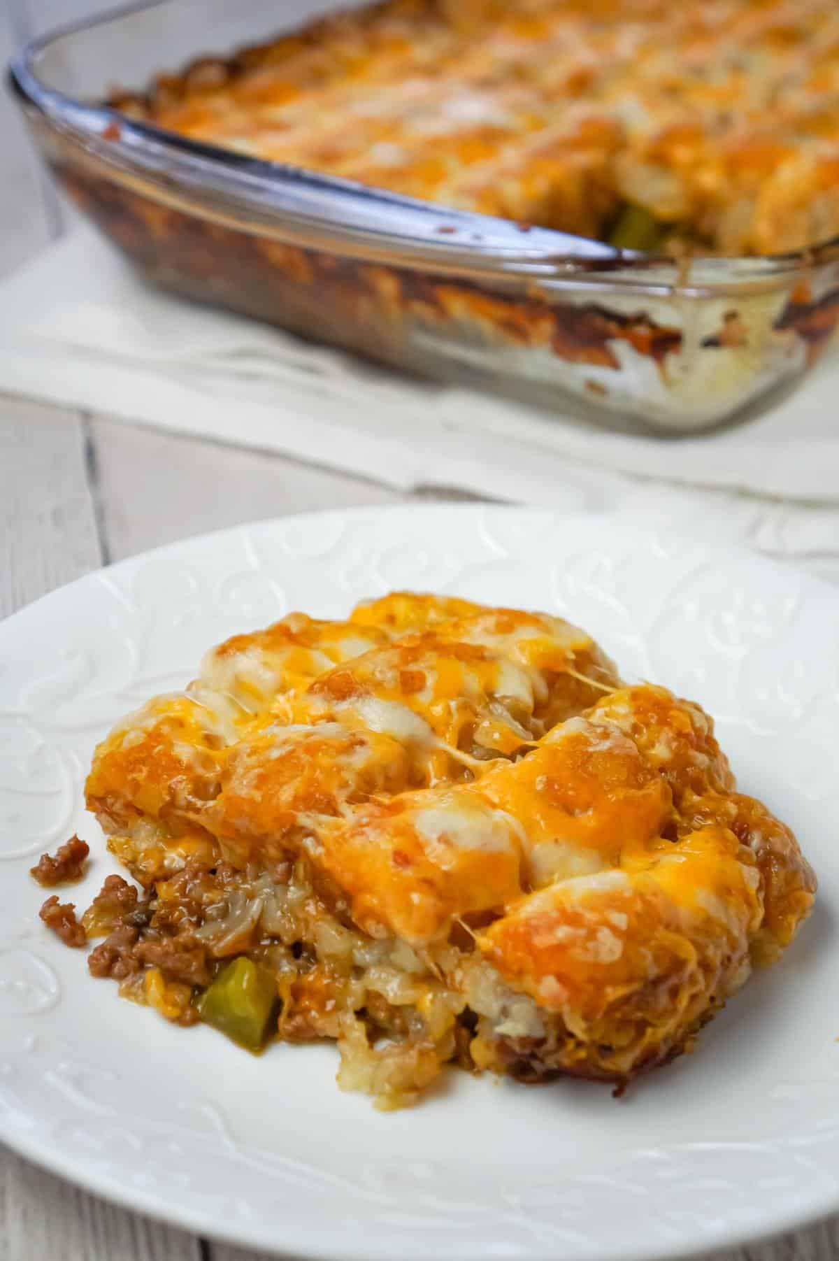 Philly Cheese Steak Tater Tot Casserole is a hearty dinner recipe with a base of ground beef, diced onion, diced green peppers and sliced mushrooms tossed in brown gravy and topped with shredded cheese and tater tots.