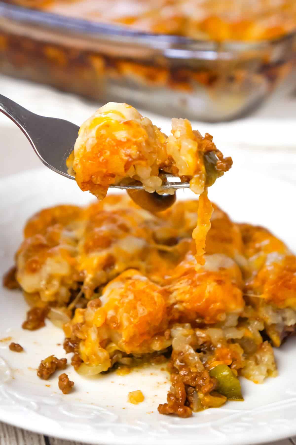 Philly Cheese Steak Tater Tot Casserole is a hearty dinner recipe with a base of ground beef, diced onion, diced green peppers and sliced mushrooms tossed in brown gravy and topped with shredded cheese and tater tots.