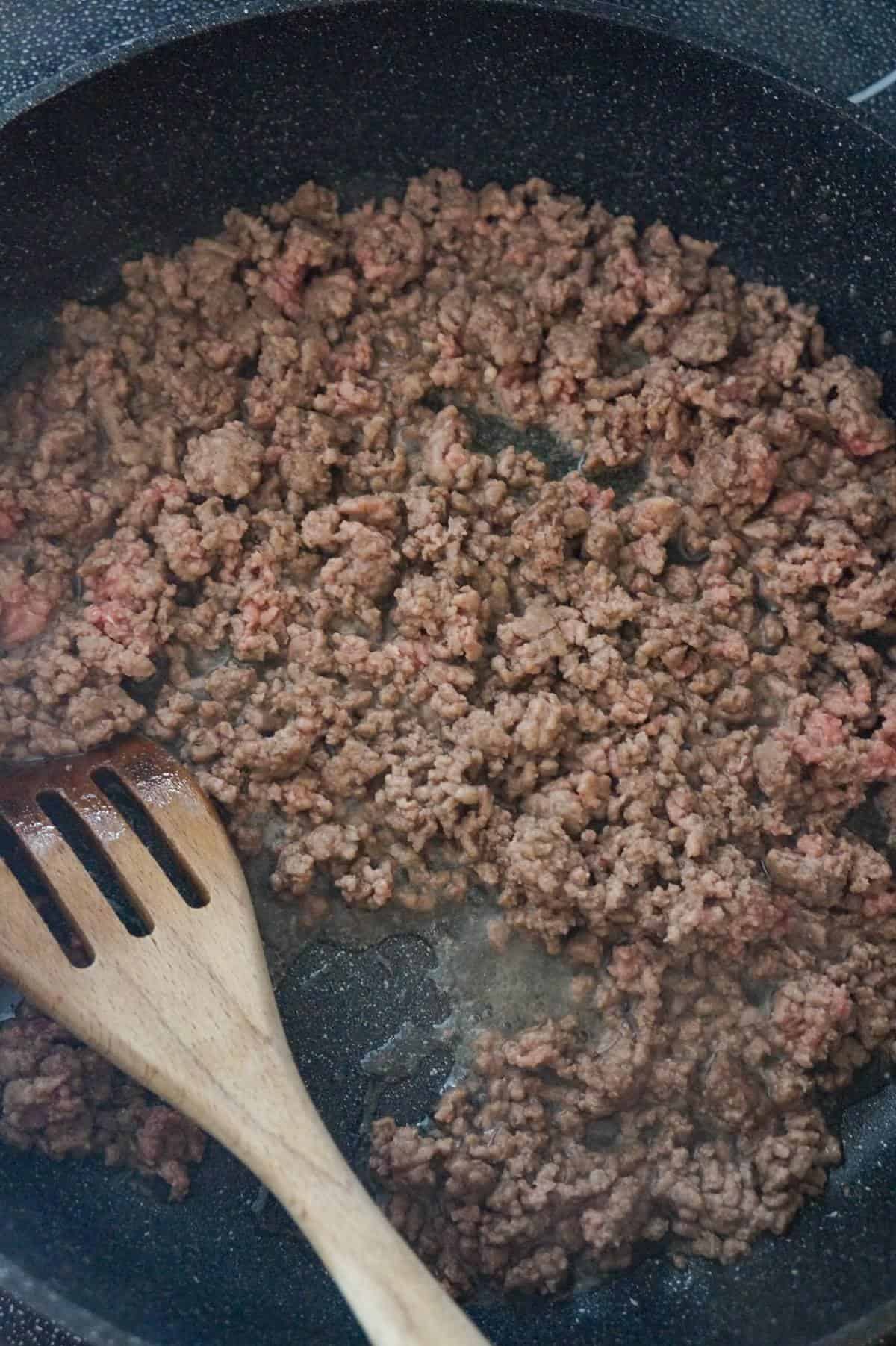ground beef cooking in a saute pan