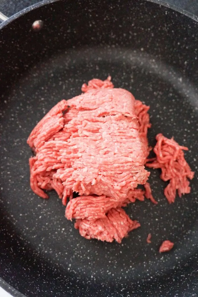 raw ground beef in a saute pan