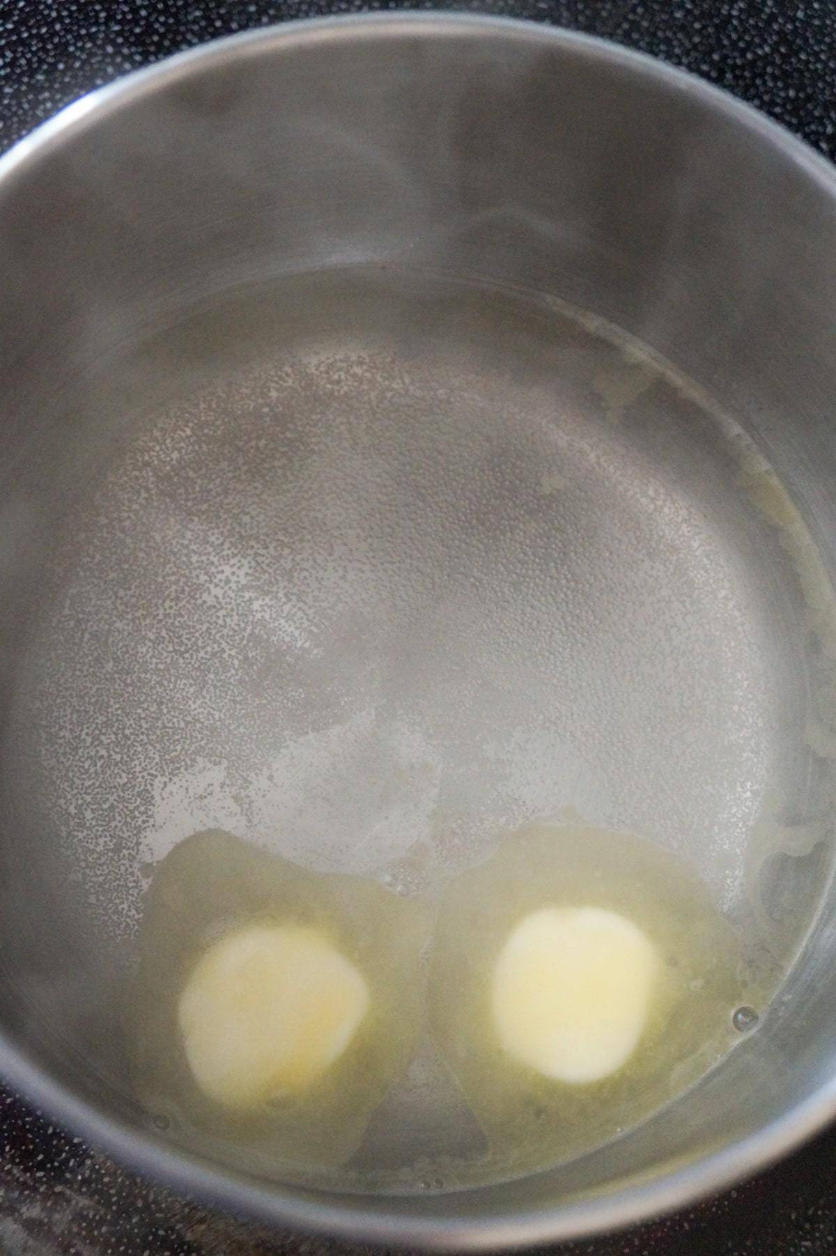 water and margarine in a pot on the stove