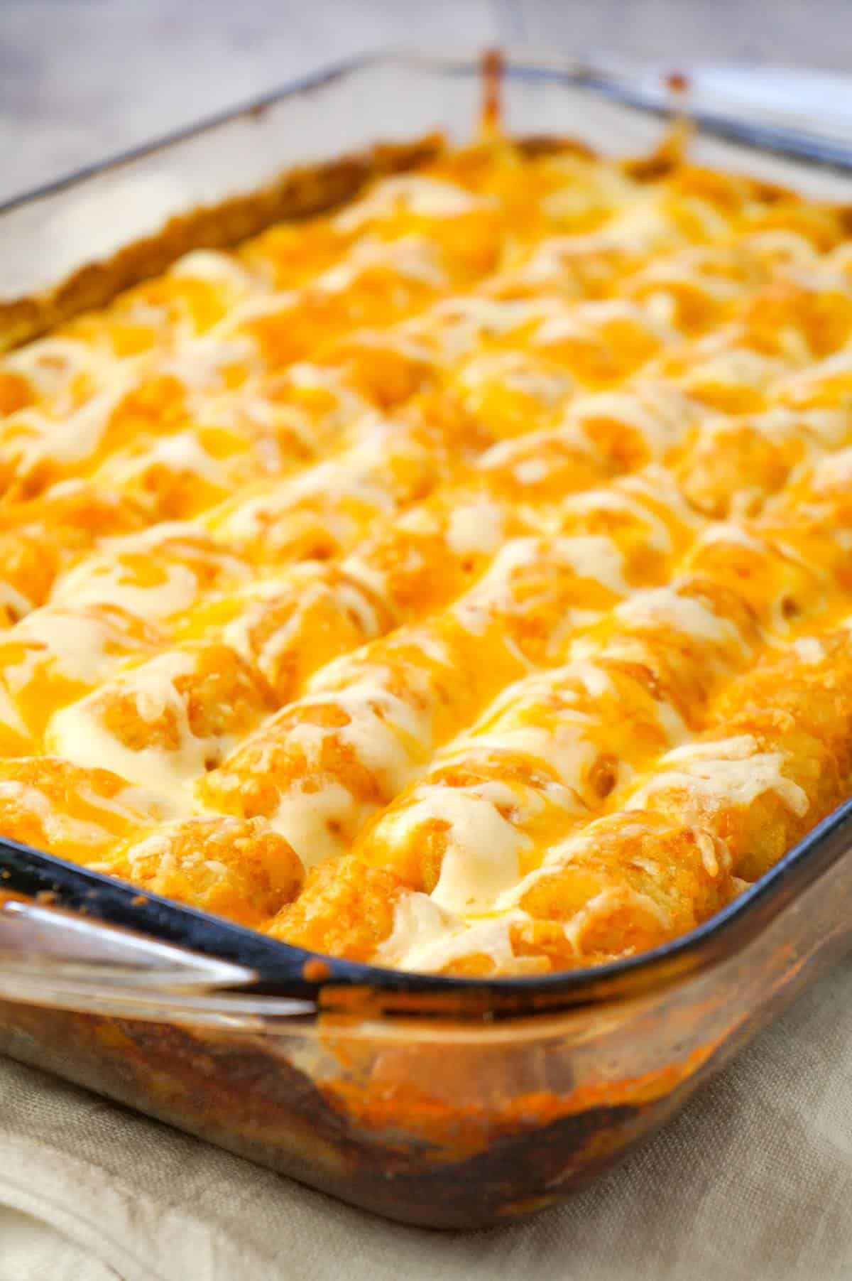 Shepherd's Pie Tater Tot Casserole is a hearty casserole with ground beef, corn and diced onions topped with mashed potatoes, tater tots and shredded cheese.