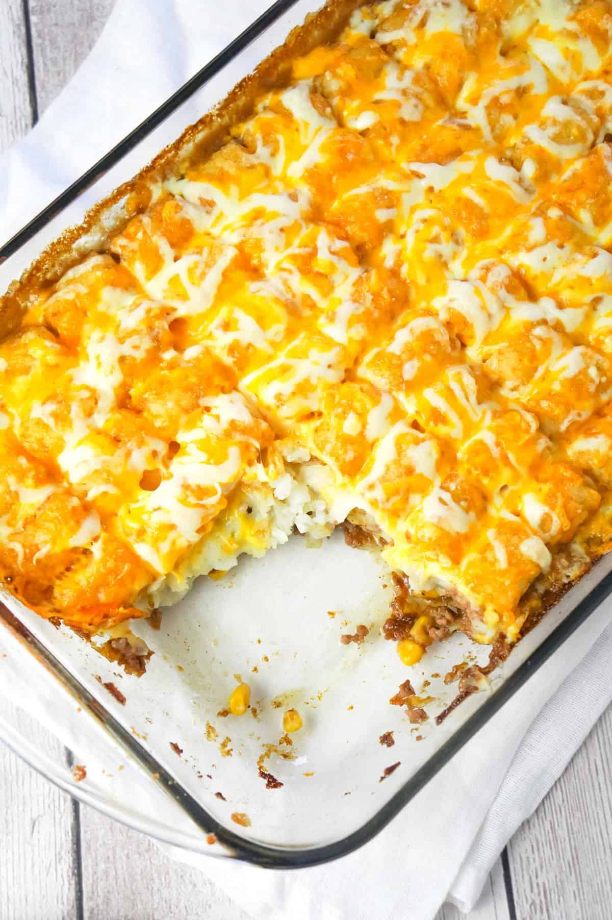 Shepherd's Pie Tater Tot Casserole is a hearty casserole with ground beef, corn and diced onions topped with mashed potatoes, tater tots and shredded cheese.