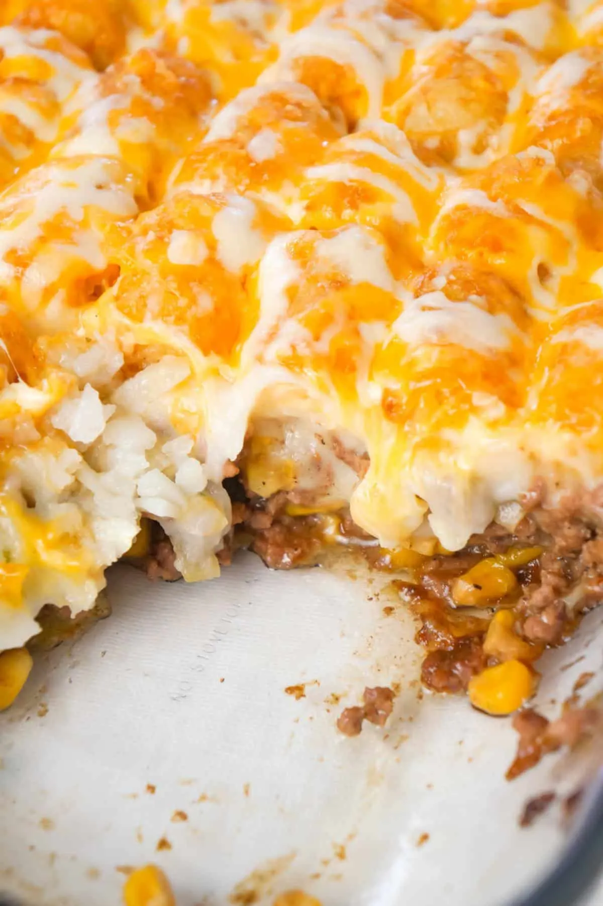 Shepherd's Pie Tater Tot Casserole is a hearty casserole with ground beef, corn and diced onions topped with mashed potatoes, tater tots and shredded cheese.