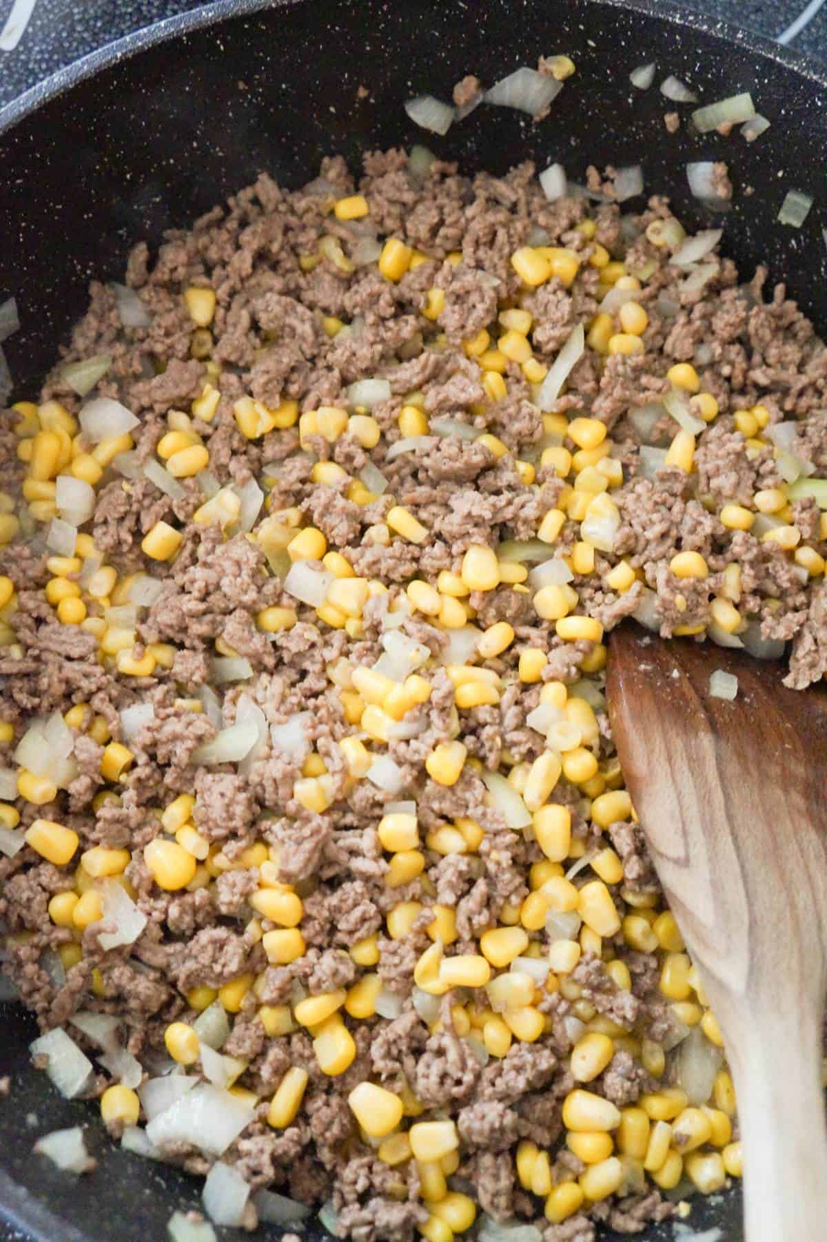 diced onions, corn and ground beef in a saute pan