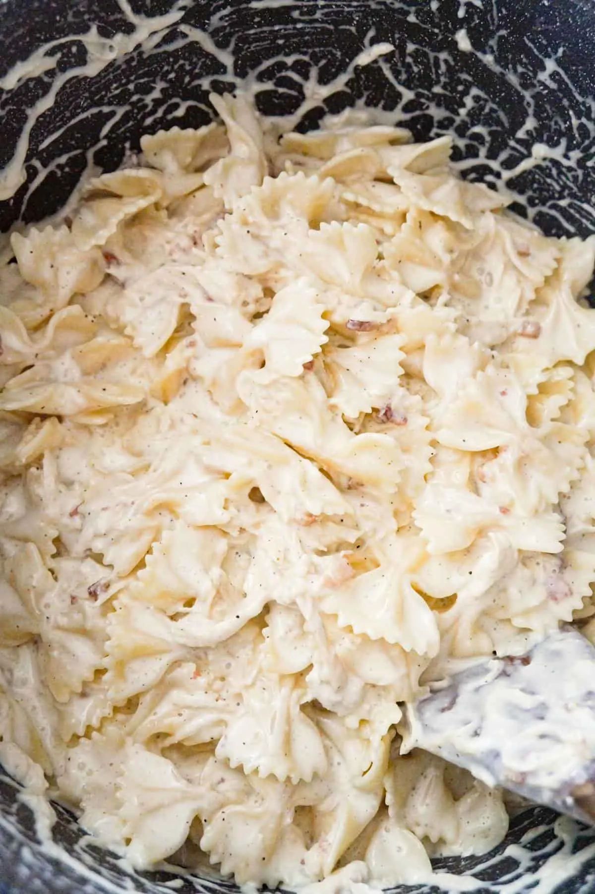 Alfredo bow tie pasta in a large pot
