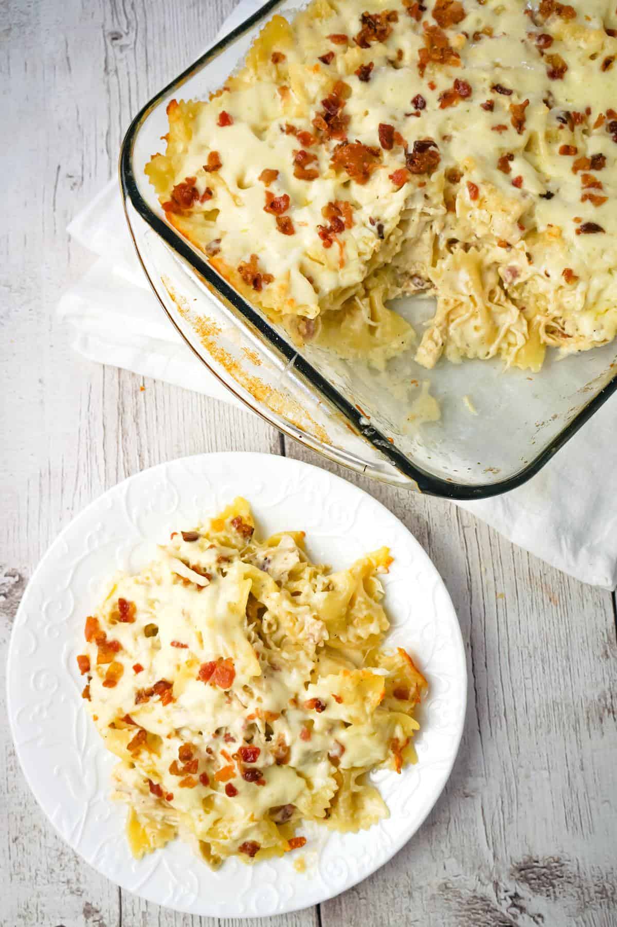 Baked Chicken Alfredo Pasta with Bacon is a delicious dinner recipe loaded with bow tie pasta, shredded chicken and crumbled bacon all in a creamy garlic Parmesan sauce and baked with mozzarella on top.