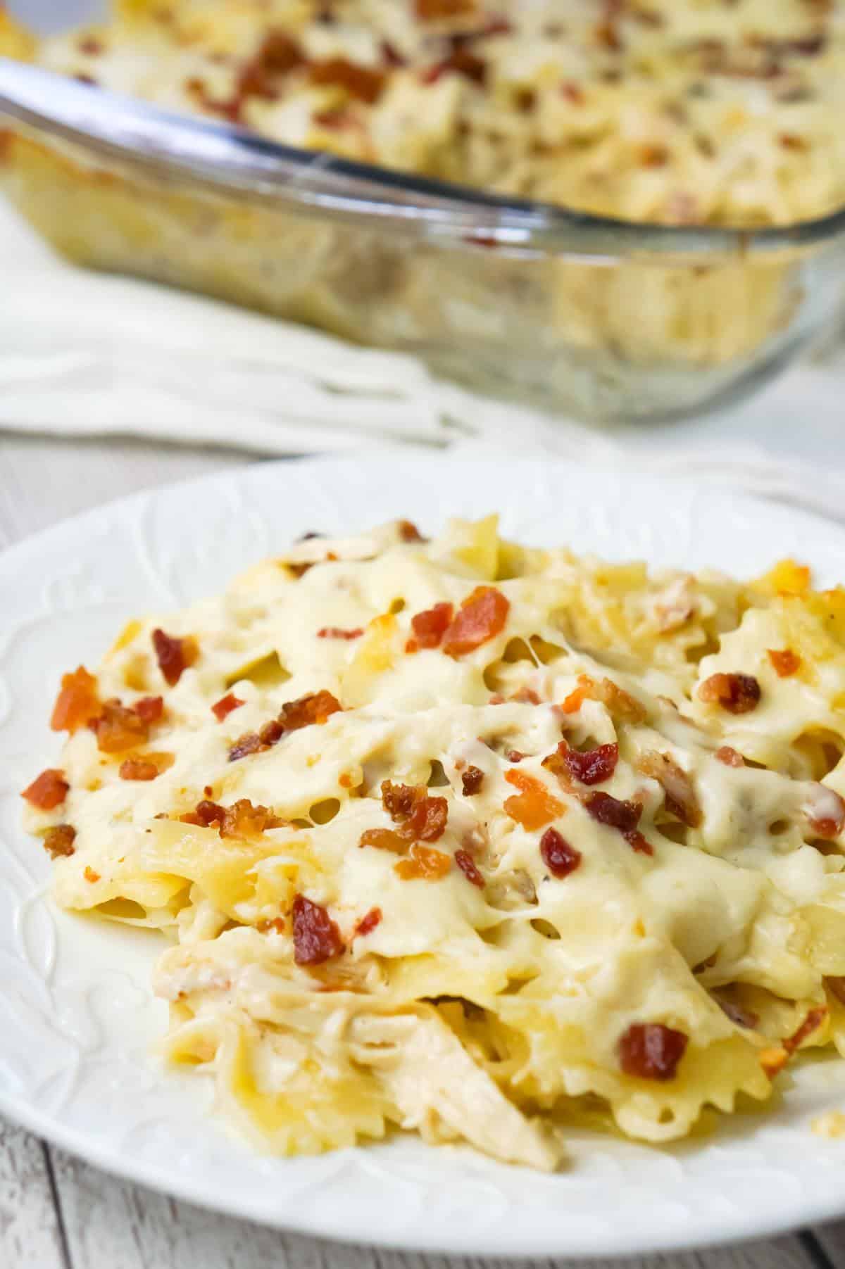 Baked Chicken Alfredo Pasta with Bacon is a delicious dinner recipe loaded with bow tie pasta, shredded chicken and crumbled bacon all in a creamy garlic Parmesan sauce and baked with mozzarella on top.