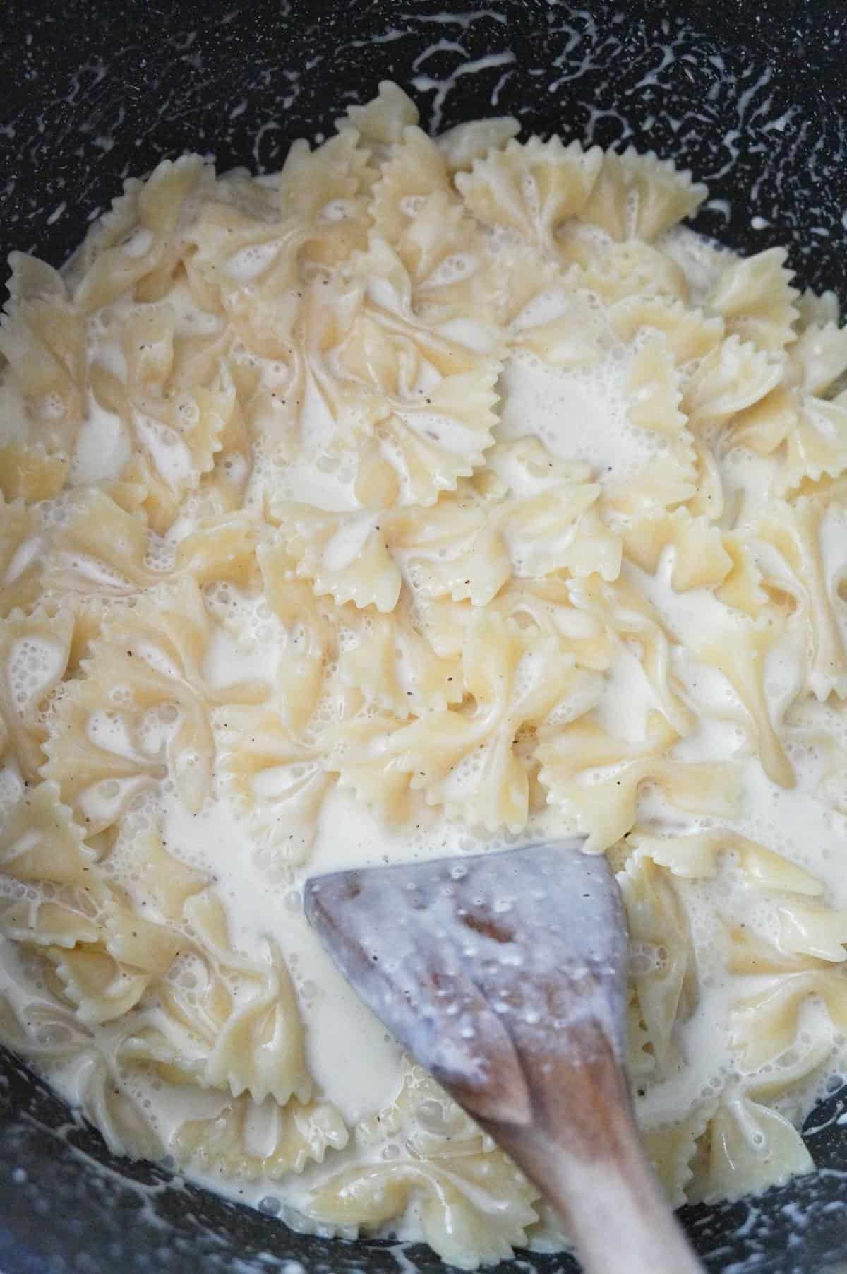 creamy bow tie pasta in a large pot