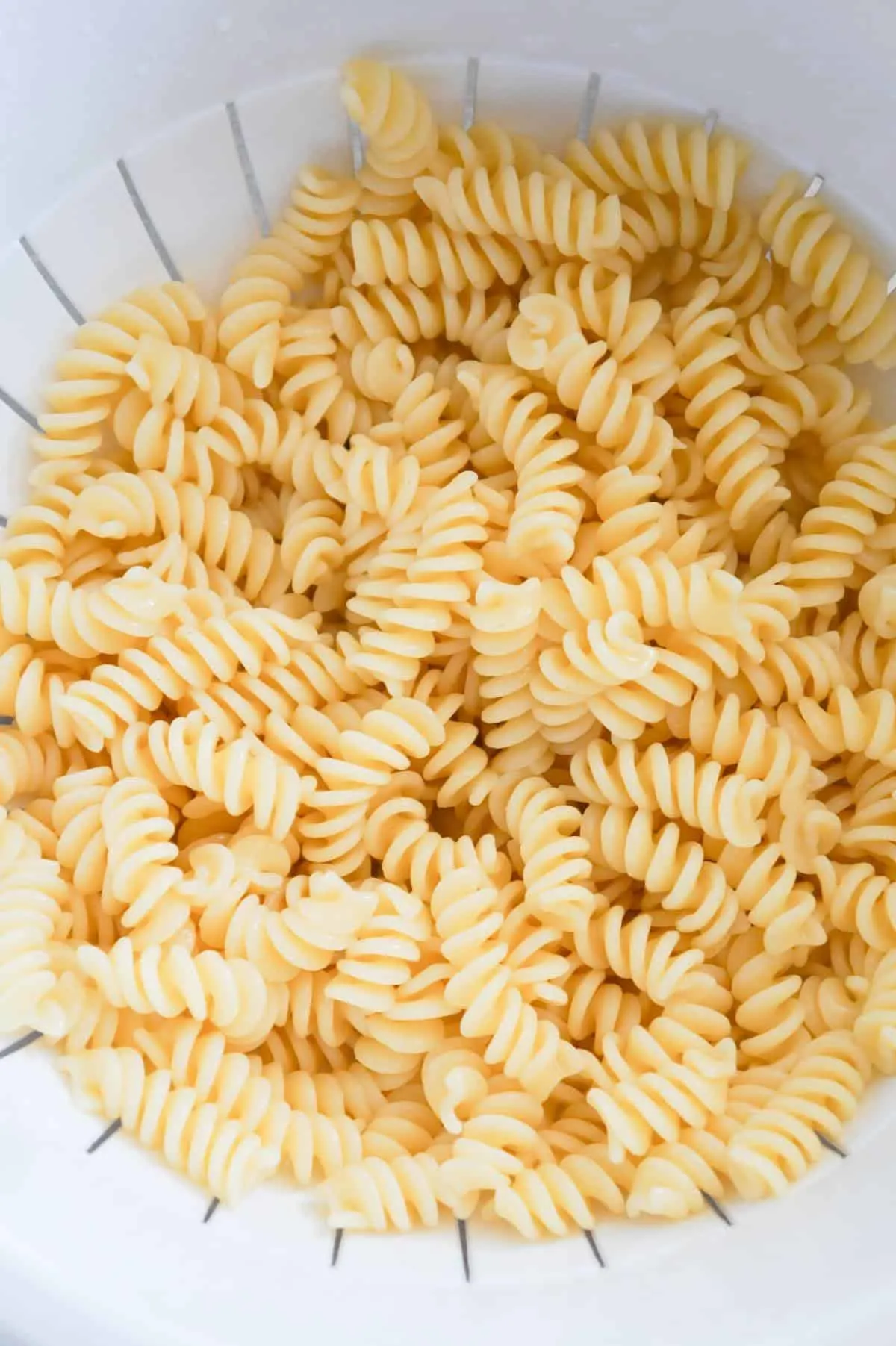 cooked fusilli noodles in a strainer