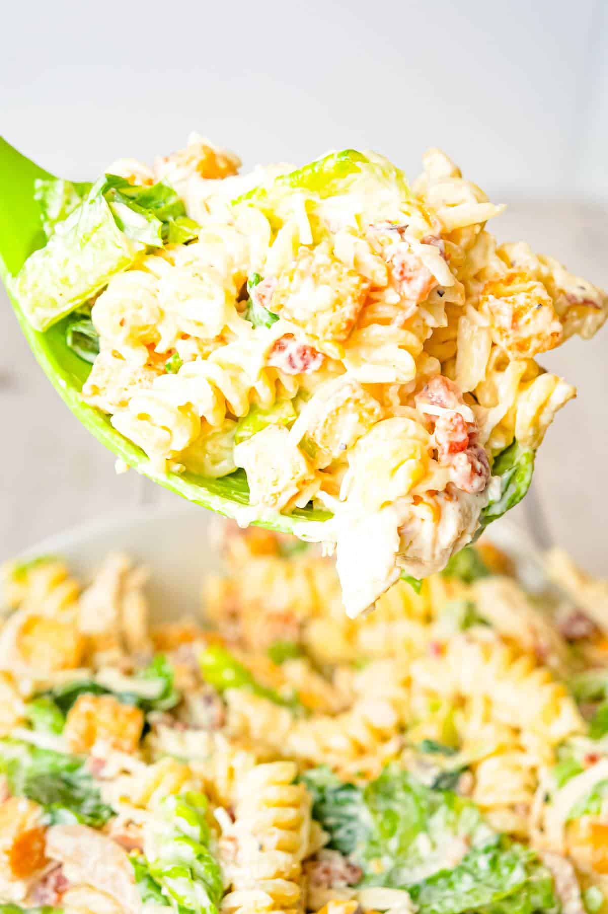 Chicken Caesar Pasta Salad is a tasty side cold dish recipe loaded with chopped romaine, shredded chicken, crumbled bacon, croutons, shredded mozzarella, cheddar and Parmesan cheese all tossed in a creamy garlic Parmesan dressing.