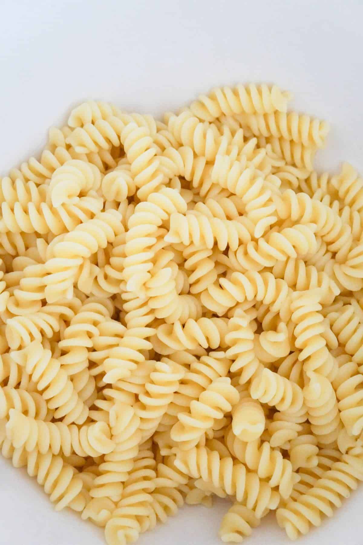 cooked fusilli noodles in a mixing bowl