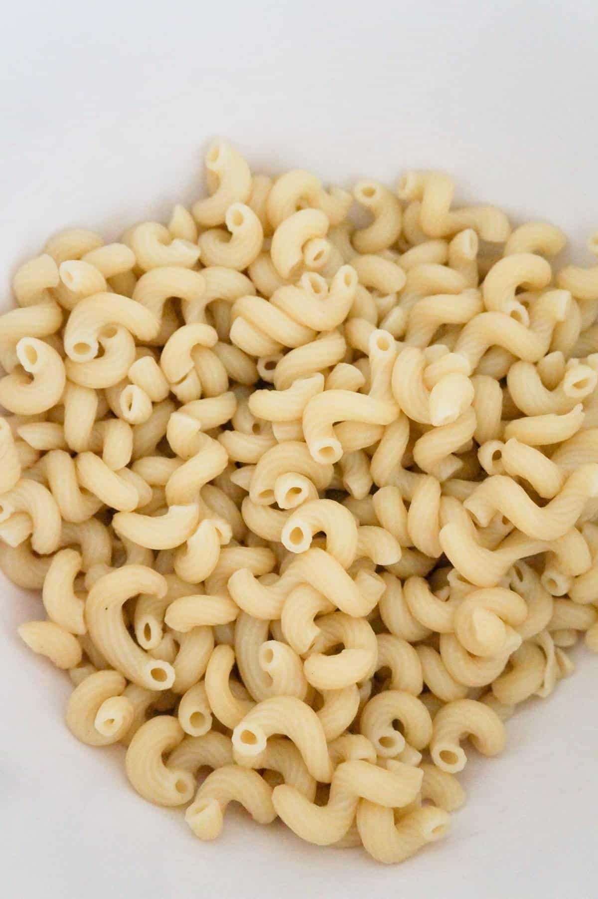 cooked cavatappi noodles in a mixing bowl