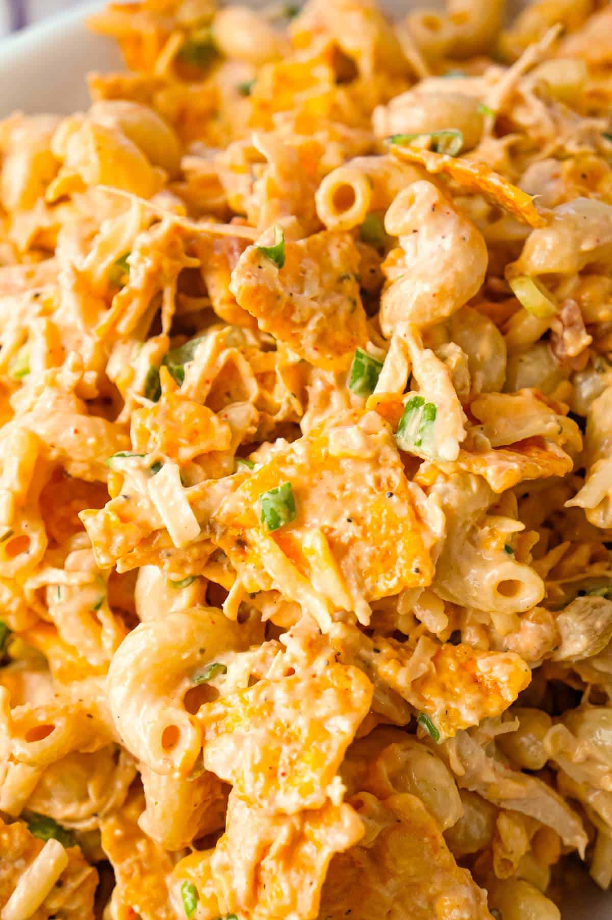 Doritos Chicken Pasta Salad is a tasty cold side dish recipe loaded with shredded chicken, chopped green onions, ranch dressing, salsa, shredded cheese and crumbled Doritos.