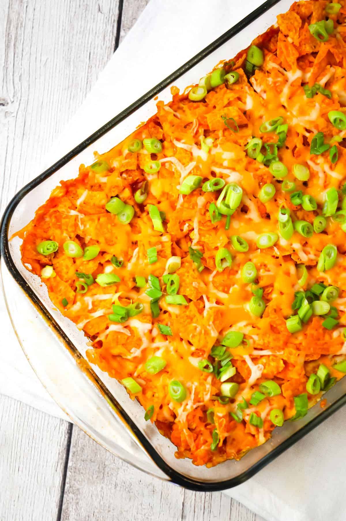 Doritos Chili Pie is an easy ground beef casserole recipe loaded with chili sauce, chunky salsa, corn, shredded cheese, crumbled Doritos and chopped green onions.