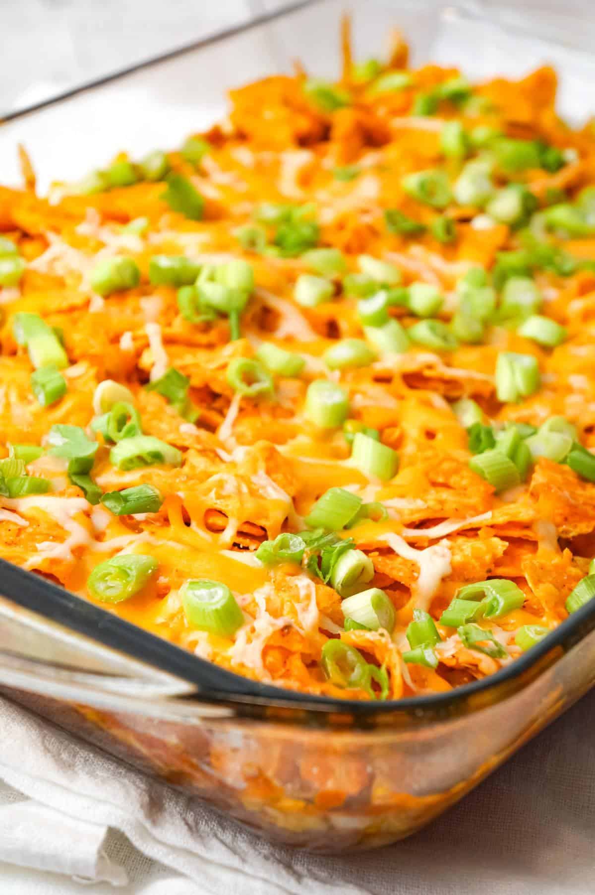 Doritos Chili Pie is an easy ground beef casserole recipe loaded with chili sauce, chunky salsa, corn, shredded cheese, crumbled Doritos and chopped green onions.