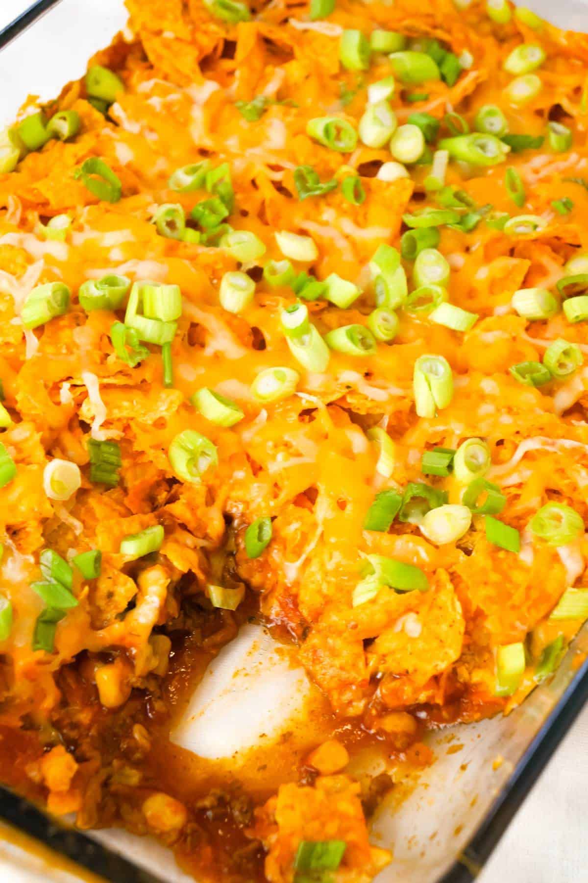 Doritos Chili Pie is an easy ground beef casserole recipe loaded with chili sauce, chunky salsa, corn, shredded cheese, crumbled Doritos and chopped green onions.