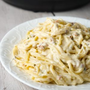 Instant Pot Bacon Cream Cheese Spaghetti is an easy pasta recipe made with heavy cream, chive and onion cream cheese, cream of bacon soup, shredded cheese and crumbled bacon.