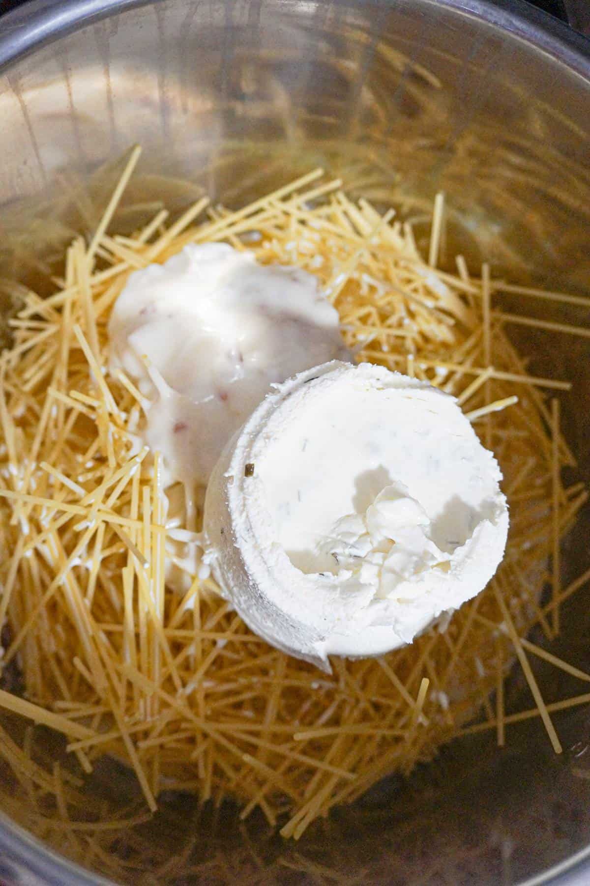 cream cheese and bacon soup on top of spaghetti noodles in an Instant Pot