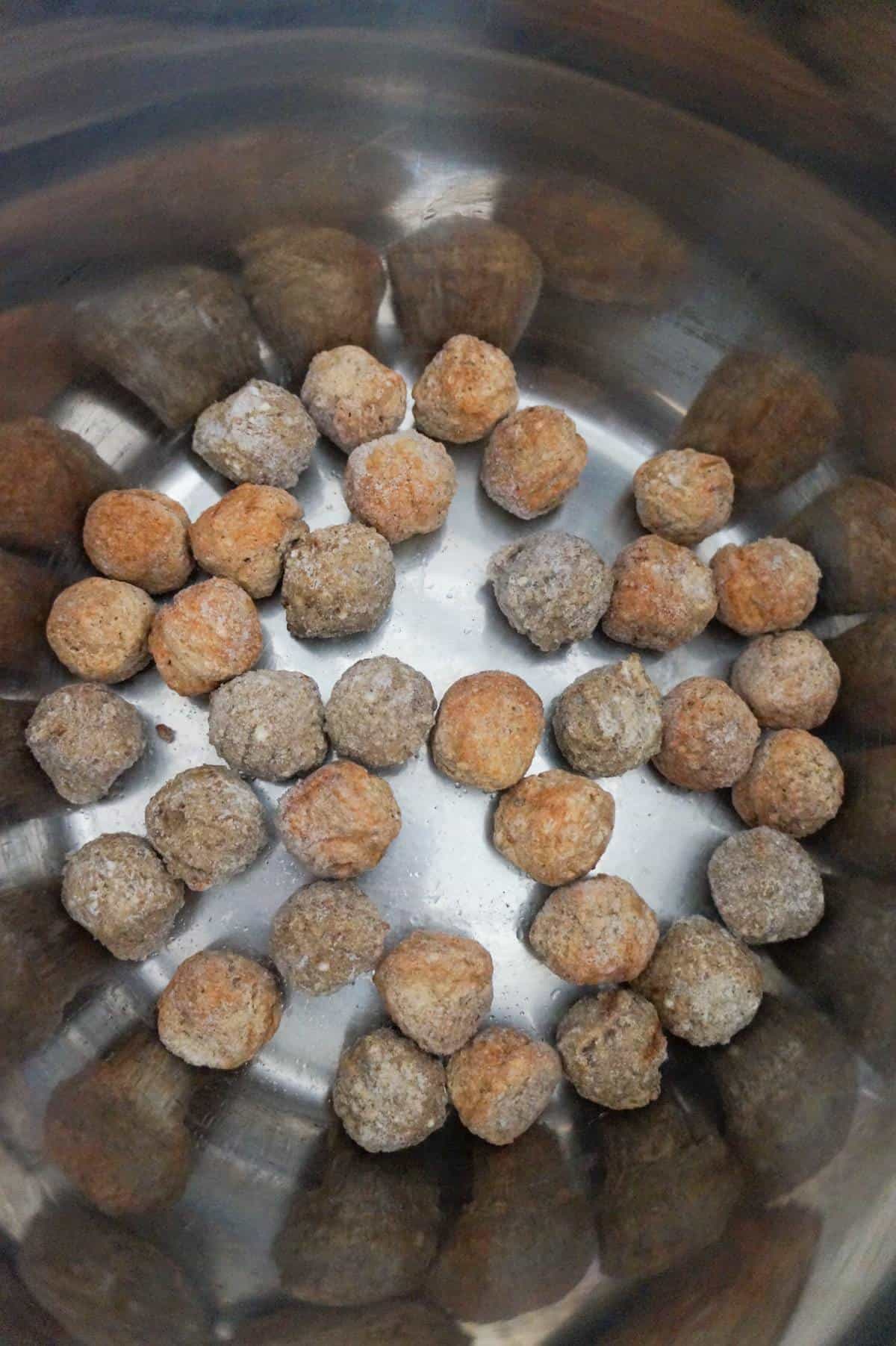 frozen meatballs in the bottom of an Instant Pot