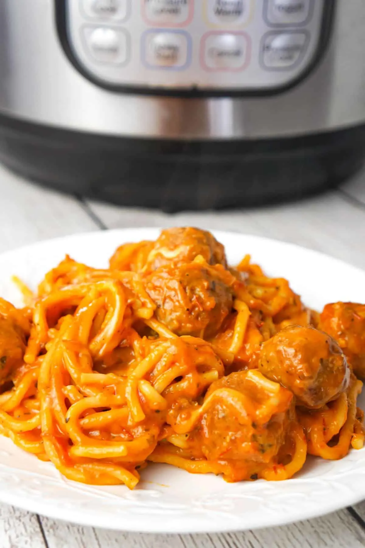 Instant Pot Cheesy Spaghetti and Meatballs is an easy and delicious pressure cooker pasta recipe loaded with Italian meatballs, shredded mozzarella and cheddar cheese and marinara sauce.