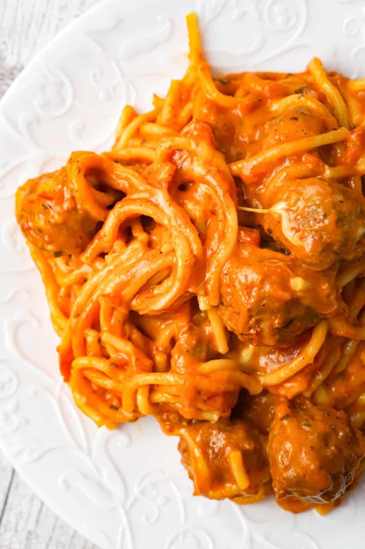 Instant Pot Cheesy Spaghetti and Meatballs is an easy and delicious pressure cooker pasta recipe loaded with Italian meatballs, shredded mozzarella and cheddar cheese and marinara sauce.