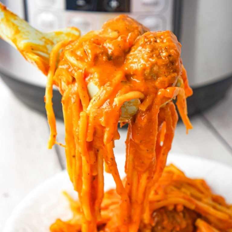 Instant Pot Cheesy Spaghetti and Meatballs is an easy and delicious pressure cooker pasta recipe loaded with Italian meatballs, shredded mozzarella and cheddar cheese and marinara sauce.