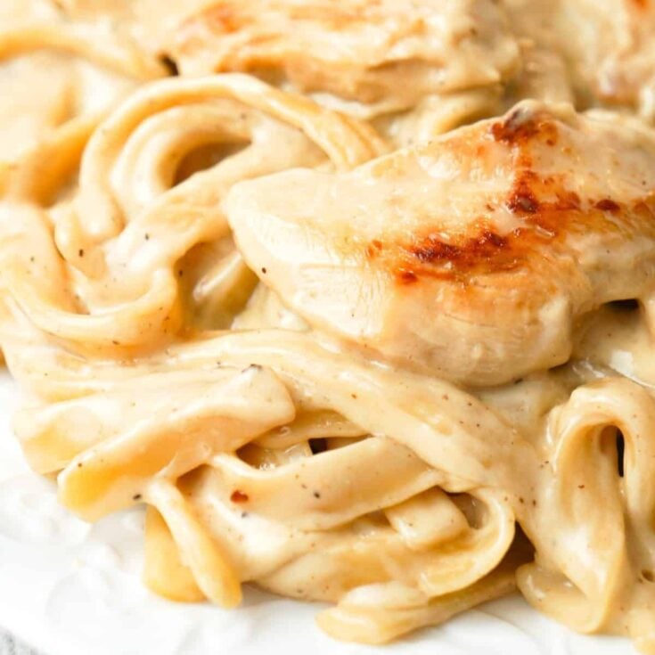 One Pot Fettuccine Alfredo with Chicken is an easy and delicious pasta recipe with a creamy garlic Parmesan sauce and loaded with slices of chicken breast.