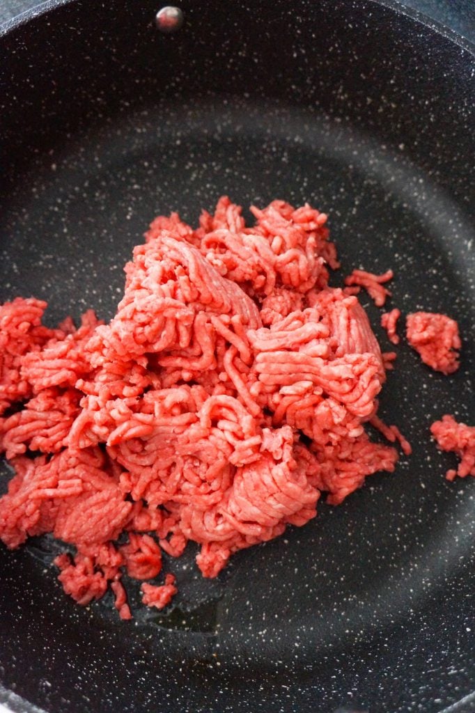 raw ground beef in a saute pan