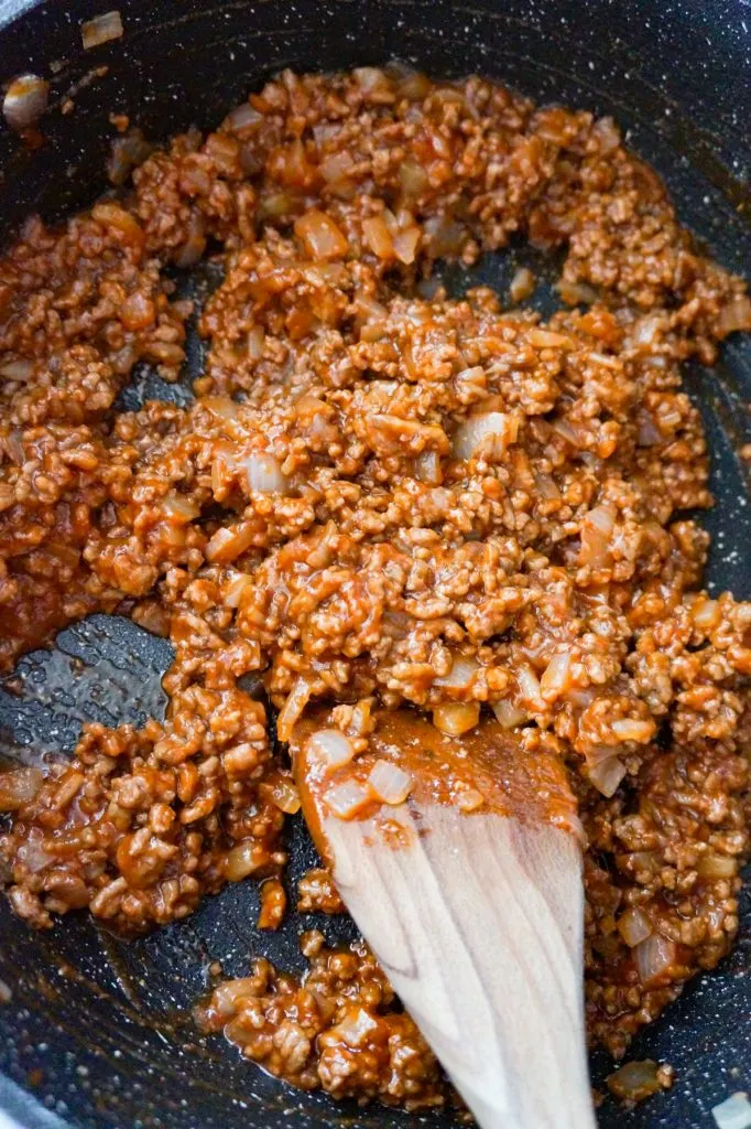ground beef coated in sloppy joe sauce in a saute pan