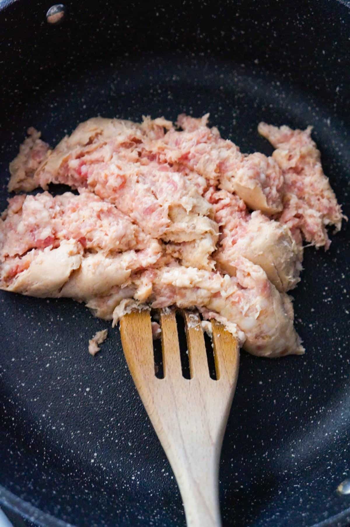 raw sausage meat in a saute pan
