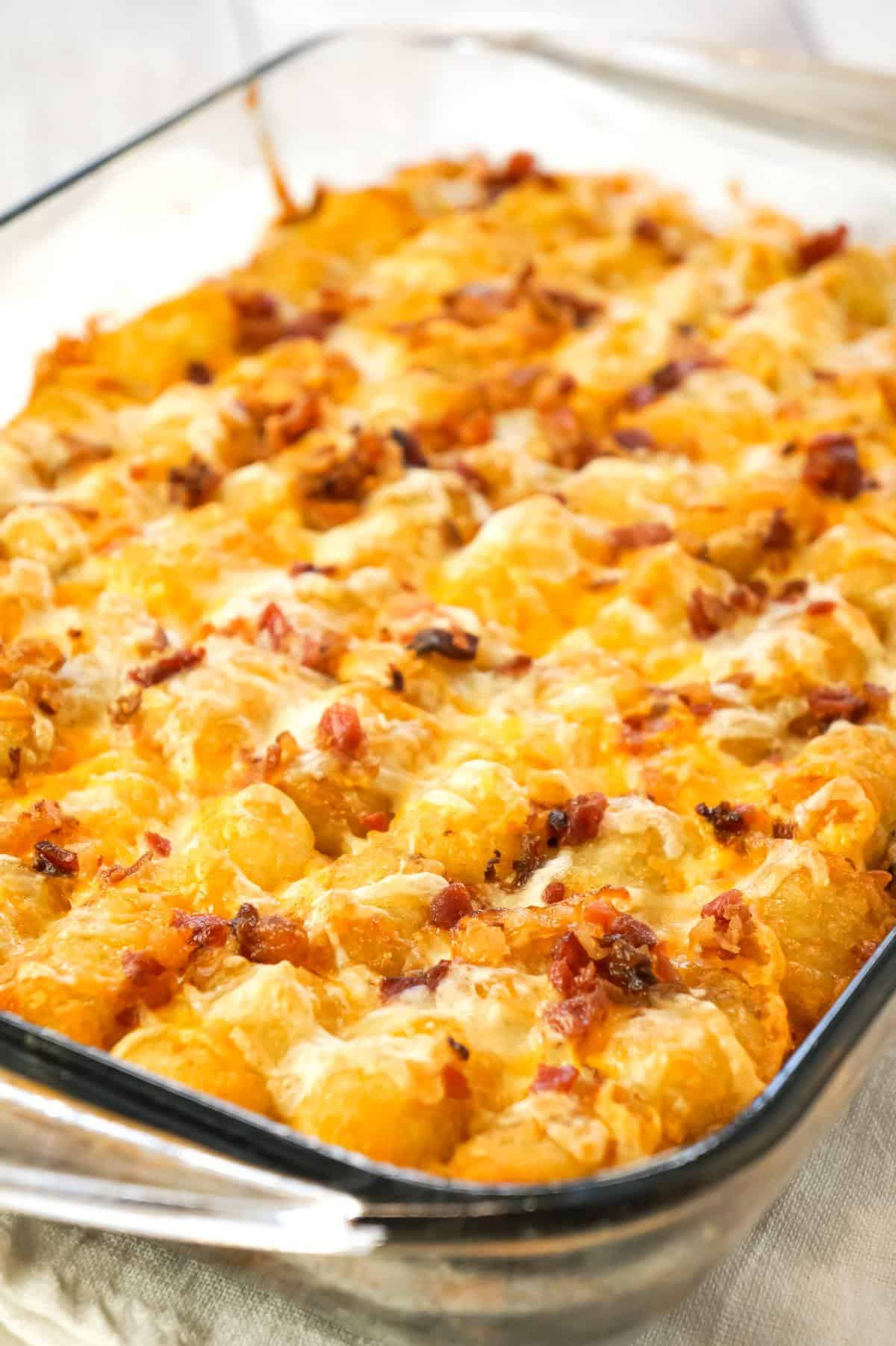 Tater Tot Breakfast Casserole is a hearty casserole recipe loaded with pork sausage meat, diced onion, chopped ham, crumbled bacon, eggs, shredded cheese and topped with tater tots.